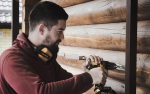 photo of man restoring the disadvantages of his timber frame house