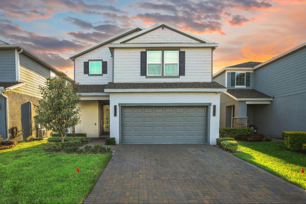 Exterior of a two-story move-in ready home with a garage in St. Pete, ideal for buyers searching for new St. Pete homes for sale.